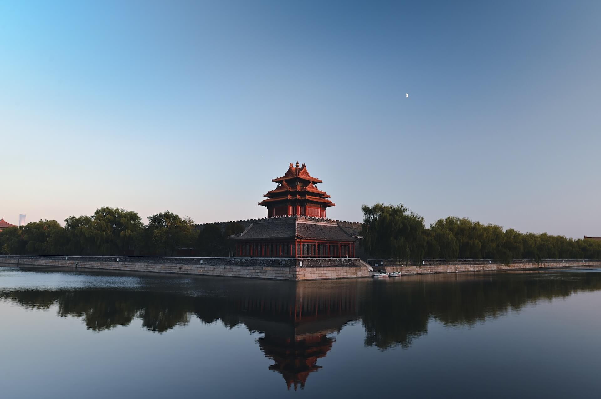 Brown and black temple near body of water during daytime
