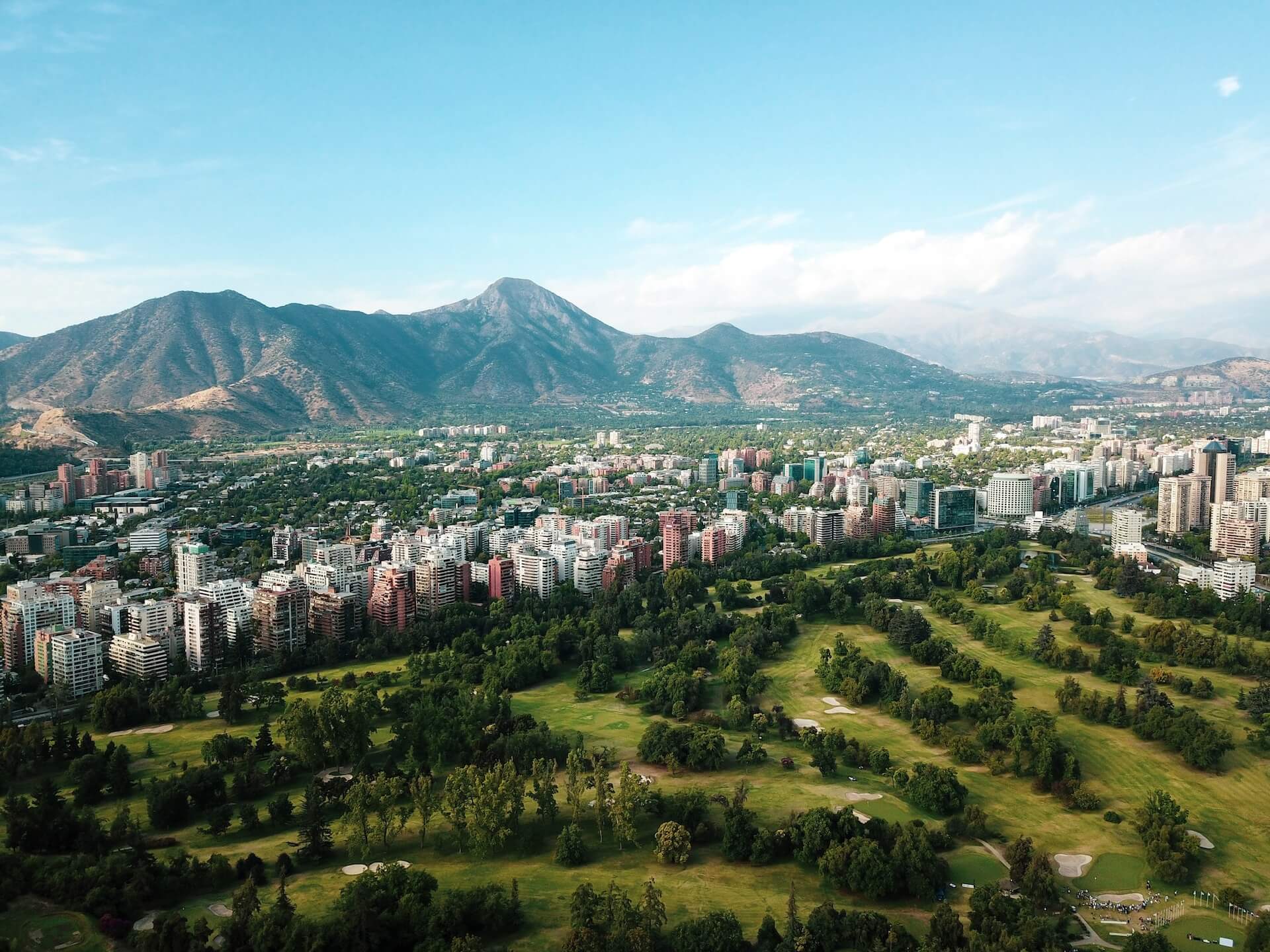City buildings on green grass field during daytime